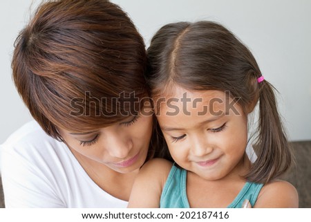 daughter comforted by her caring mother, concept of family relationship