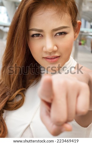 confident woman pointing finger at you
