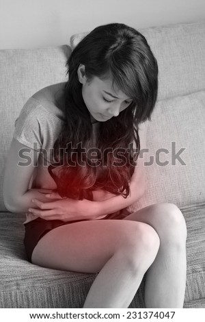 menstruation pain, period cramp, stomach ache, digestive problem of woman in indoor scene