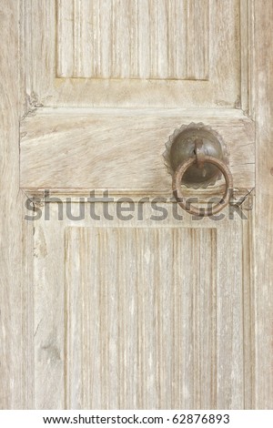 old wood door or partition design with rusted ring door knocker 