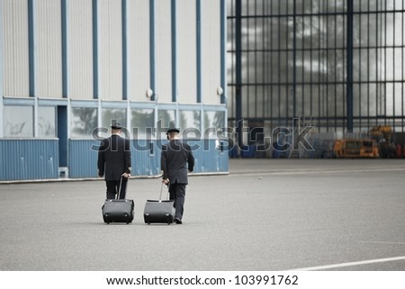 Flight crew is walking to hangar - selective focus