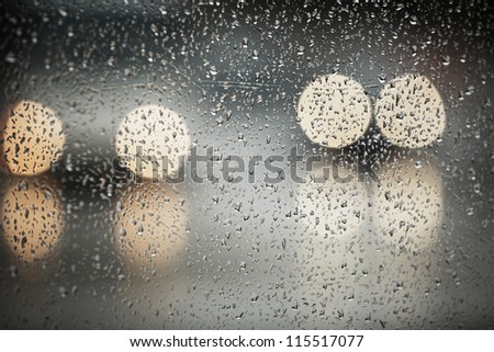 Rain in the city - selective focus on the raindrop