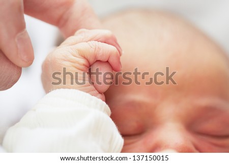 Newborn baby with father - selective focus