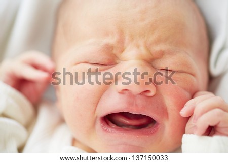Newborn baby is crying - selective focus