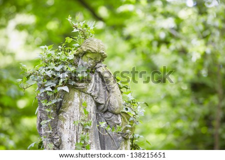 Sad angel statue on old cemetery