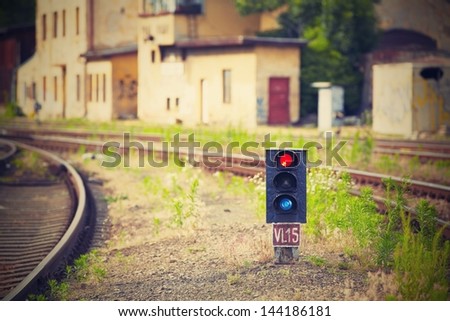 Traffic light shows red signal on railway - Railway station.