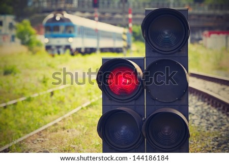 Traffic light shows red signal on railway - Railway station.