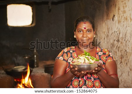 Woman is preparation food in ancient kitchen - Poverty life in village in Sri Lanka