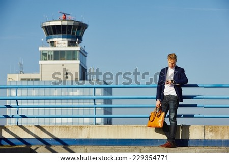 Handsome businessman is waiting at the airport