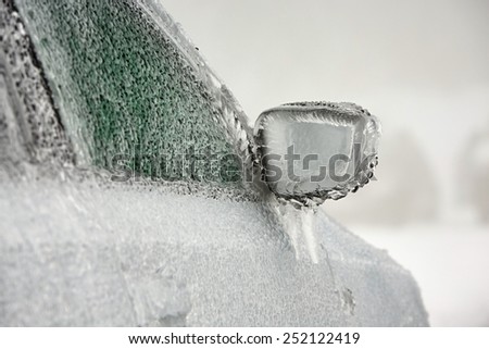 Car on the street covered by icy rain.