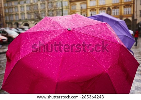 People with umbrellas in heavy rain - Prague, Czech Republic