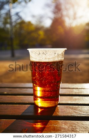 Cup of beer in garden restaurant