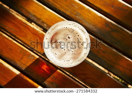 Cup of beer in garden restaurant