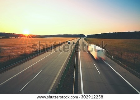 Traffic on the highway at the sunrise