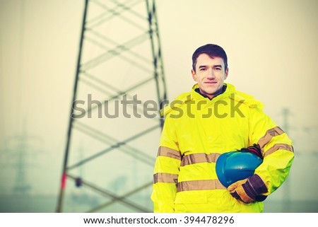 Worker wearing reflective clothing with helmet.