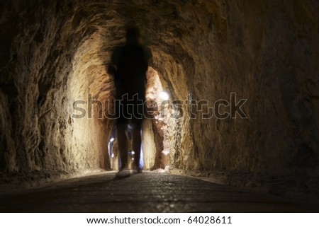Mystery man through a corridor of rock.