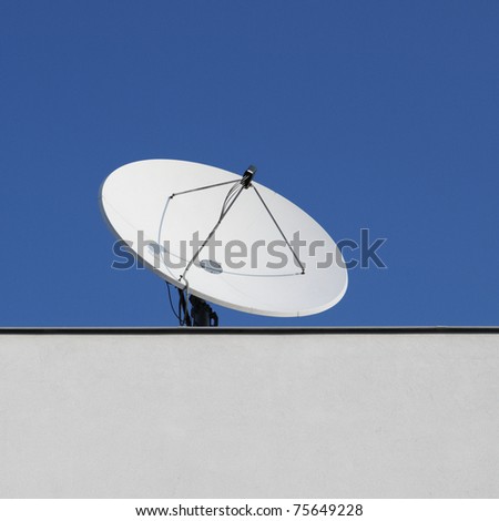 The satellite dish on the roof building.