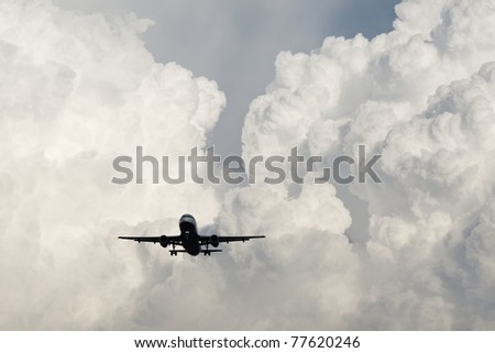 Airplane is landing from storm clouds.