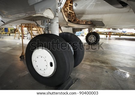 Landing gear of airplane under maintenance.