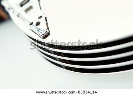 Opened hard disk, macro with very narrow focus, focused on magnetic read-write head, color manipulated