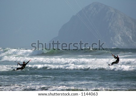 Kite surfers (kite boarder) riding the waves near Morro Bay, CA