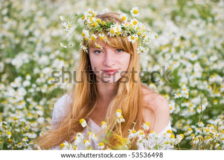 beautiful girl in a camomile wreath