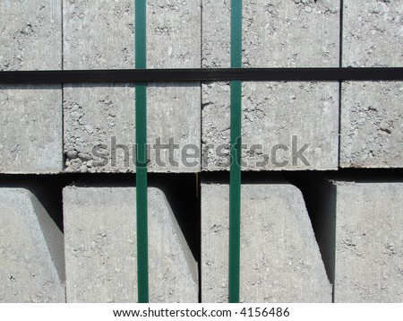 beton blocks bound by green strong ropes