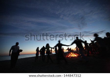 People dancing around a fire