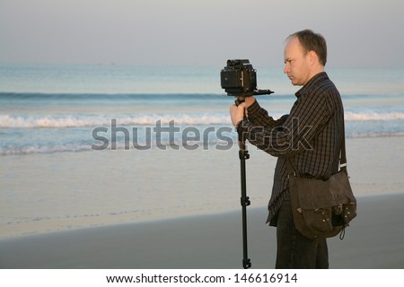 Photographer in the beach, India