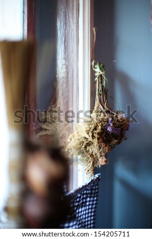 Withered plants hanging near the window