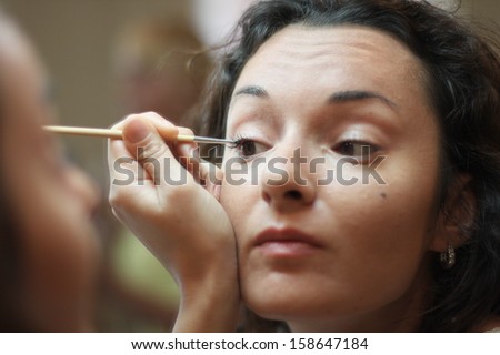 Beautiful woman drawing eye line
