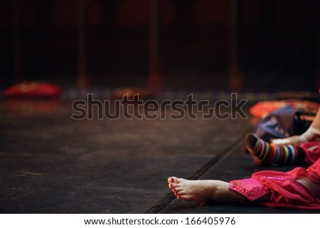 Ballerina sitting on the scene before perfomance