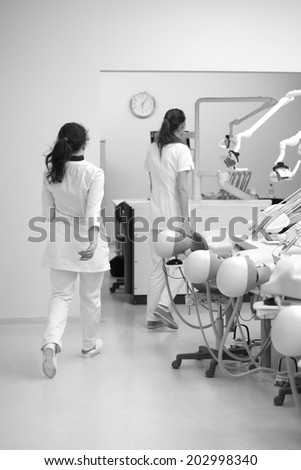 Scene of going dental students backs and  dental phantom heads