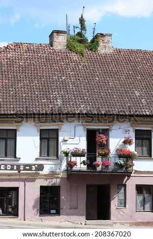 View of small town ancient architecture; two-storied house with balcony and roof tiles
