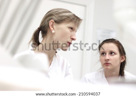 Portraits of health care workers having conversation in clinic