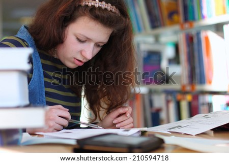 Young student reading books, preparing to the exam