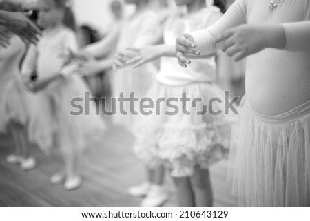 Small ladies training ballet position, mid section;monochrome;