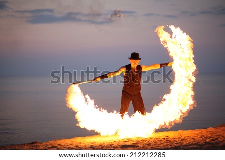 Fire torch twirling on the beach
