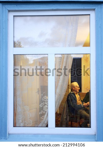 View through the window, retired old man in his home