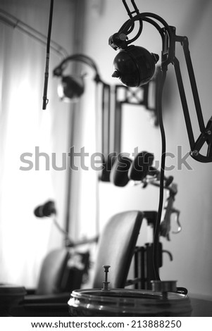 Vintage medical clinic; dentist\'s chair and equipment; monochrome