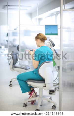 Back of dentist surfing the Internet in her spare time