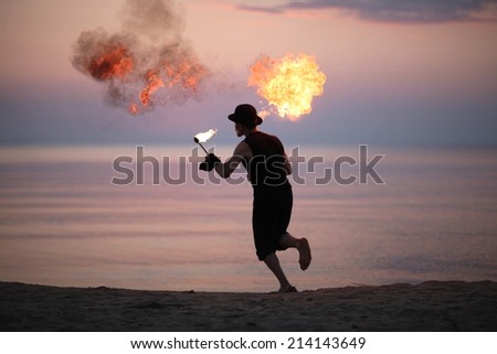 Man running with fire torch
