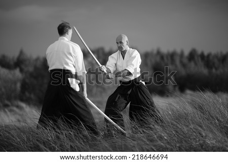 Japanese martial arts practitioners outside, monochrome