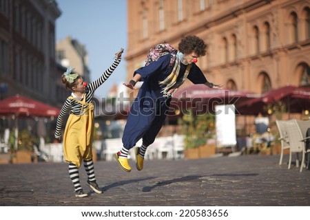 Street performance of clowns, learning to fly