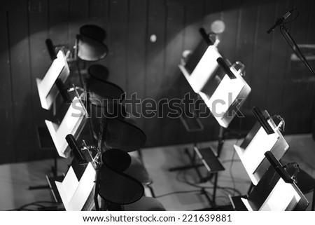 Orchestra pit, chairs and music stands; monochrome