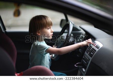 Young driver; child exploring car salon
