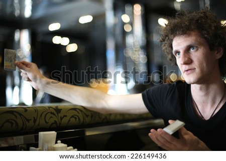 Portrait of a young man paying bill at restaurant
