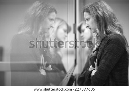 Two young women standing, reflection on the mirror, monochrome