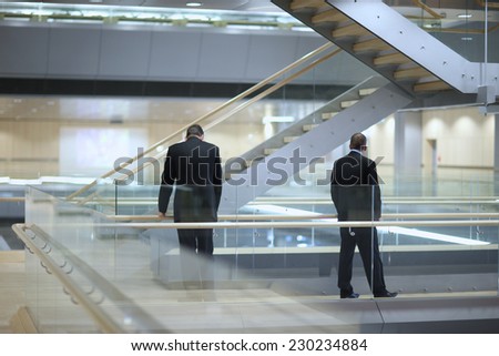 Back view of two businessmen waiting in the office lobby