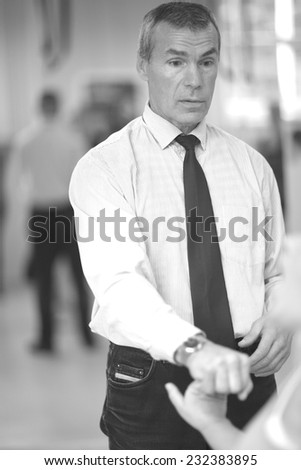 Mature man formal clothed demonstrating martial art technique